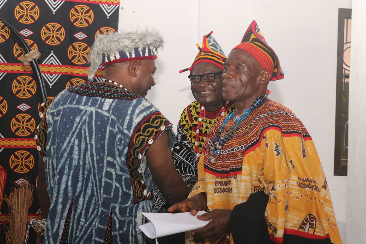 Three leaders of the Weh community dressed in their traditional regalia.